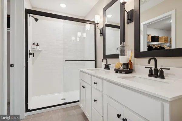 a bathroom with a double vanity sink and mirror