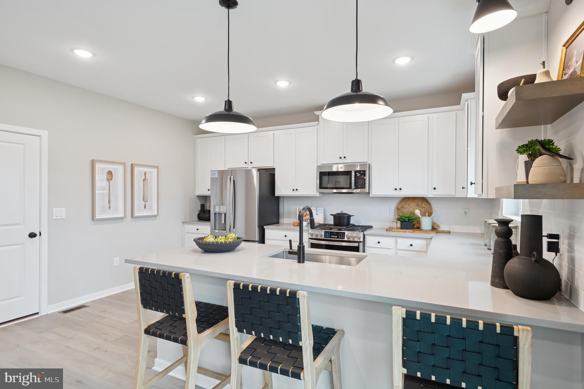 57 Sweetgum Road, Unit 33 Berlin, NJ 08009 - Photo 2 of 38 a kitchen with stainless steel appliances a dining table chairs stove and cabinets