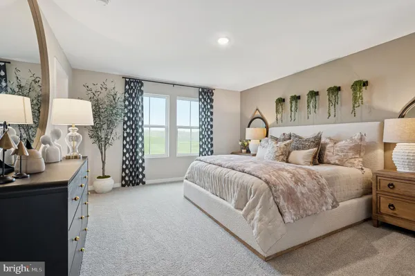 a spacious bedroom with a large bed and a table