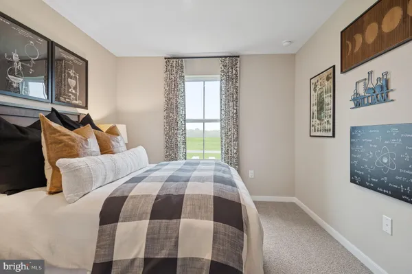 a bedroom with a bed and painting on the wall