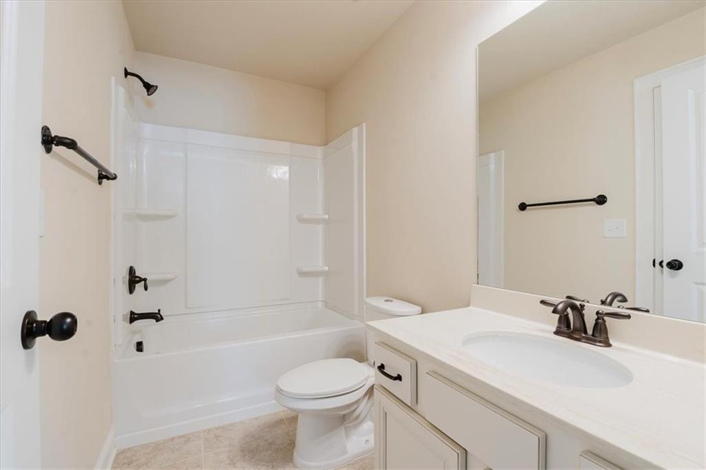 2368 Beringer Lane Powder Springs, GA 30127 - Photo 51 of 59 a bathroom with a sink a toilet and a bathtub