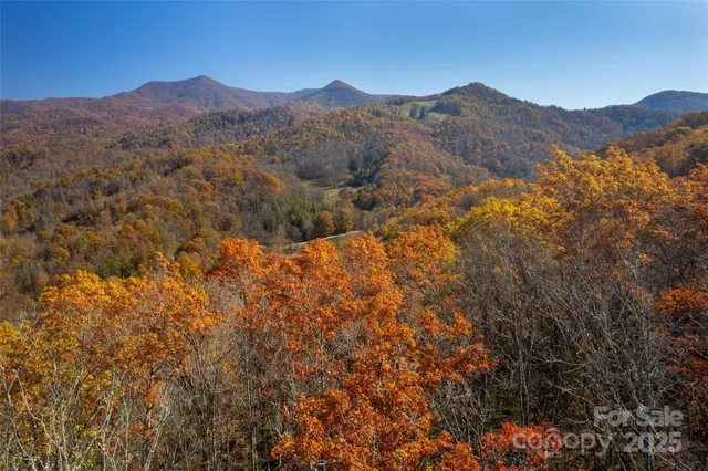 a view of a mountain range in a cloudy sky