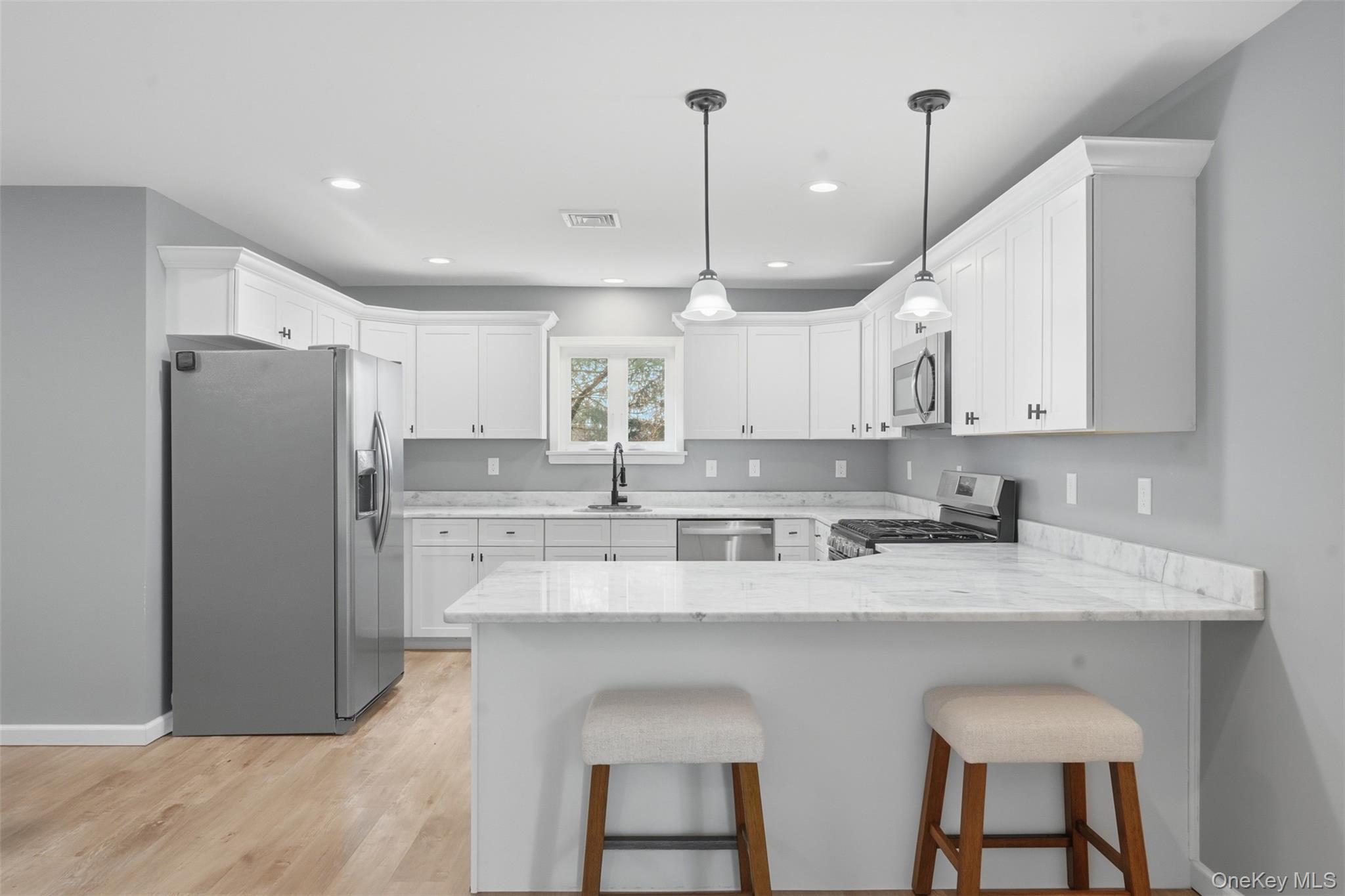 1227 Burlingham Road Pine Bush, NY 12566 - Photo 14 of 39 Kitchen featuring stainless steel appliances, a peninsula, light granite counters, a breakfast bar, and white cabinetry
