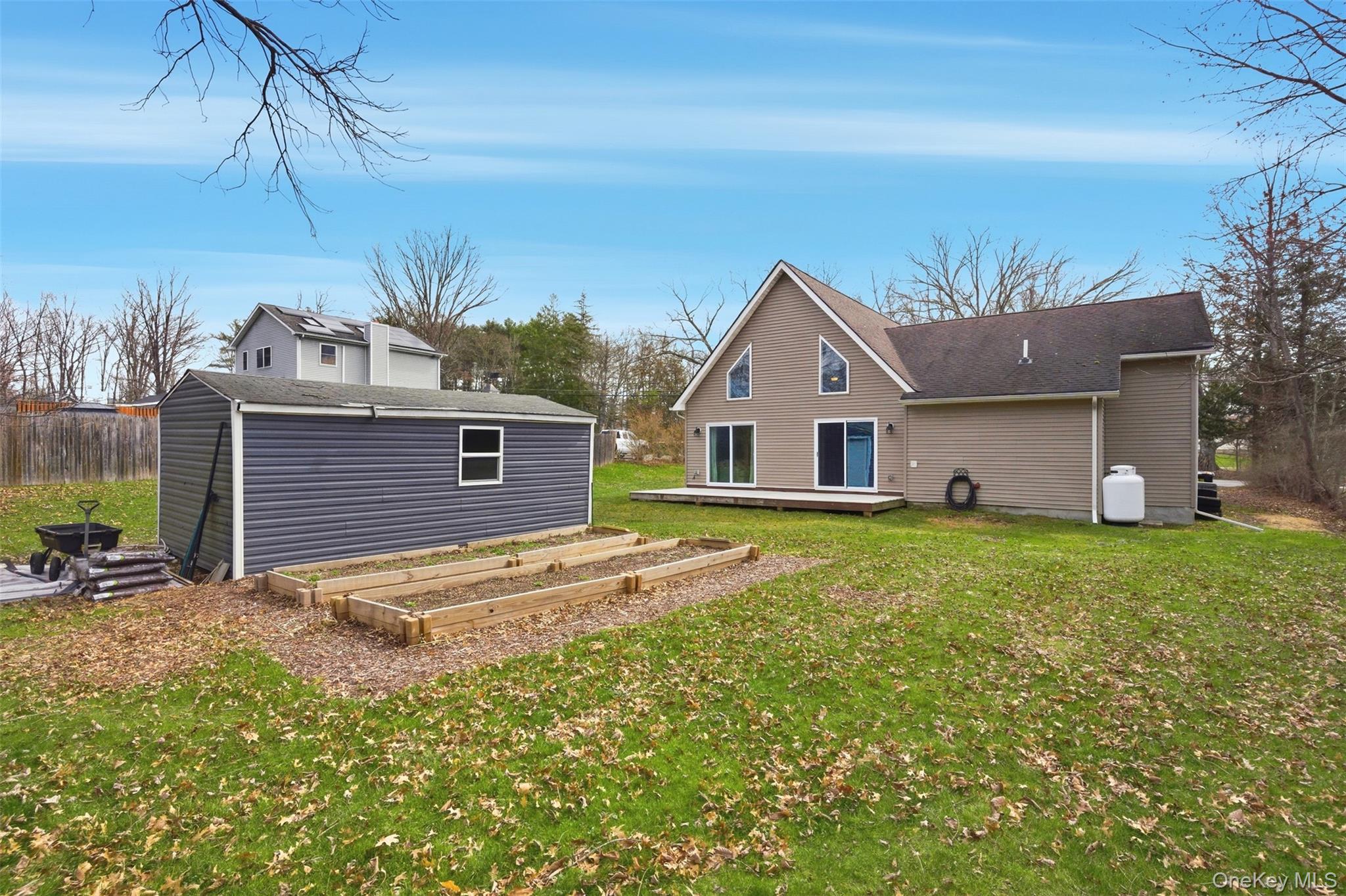 1227 Burlingham Road Pine Bush, NY 12566 - Photo 36 of 39 Rear view of property with a garden, a lawn, a deck, and a storage shed