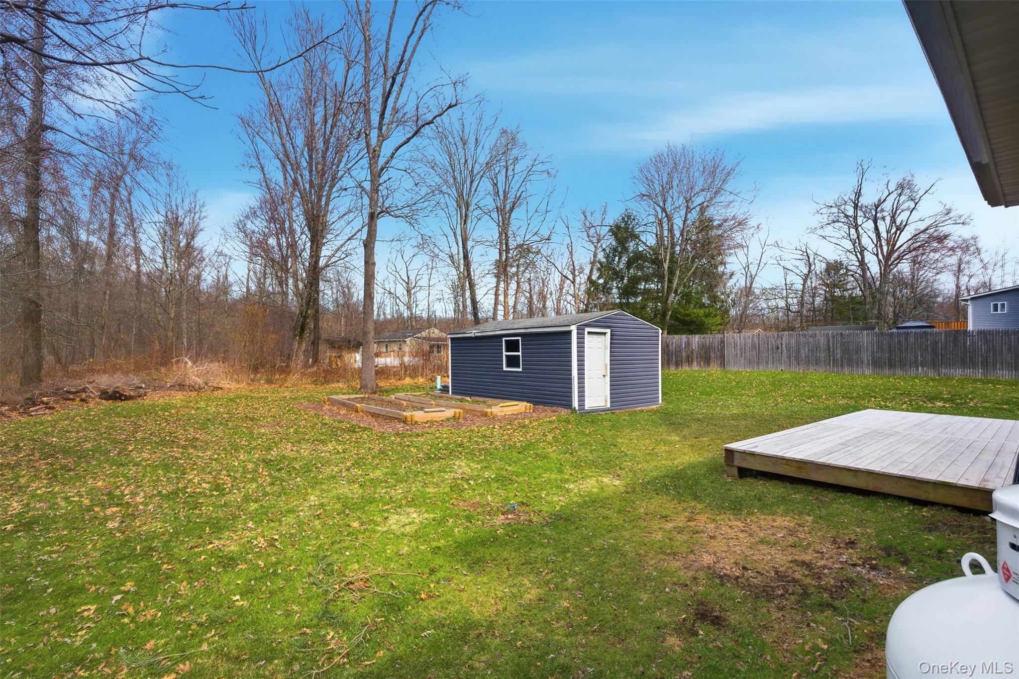 1227 Burlingham Road Pine Bush, NY 12566 - Photo 37 of 39 Fenced yard featuring a garden, a wooden deck, and a storage shed