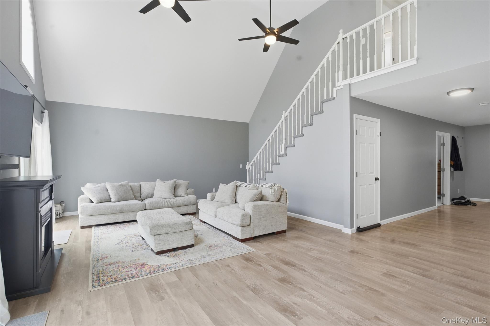 1227 Burlingham Road Pine Bush, NY 12566 - Photo 9 of 39 Living room featuring a ceiling fan, light wood-style floors, and 18 ft ceilings.