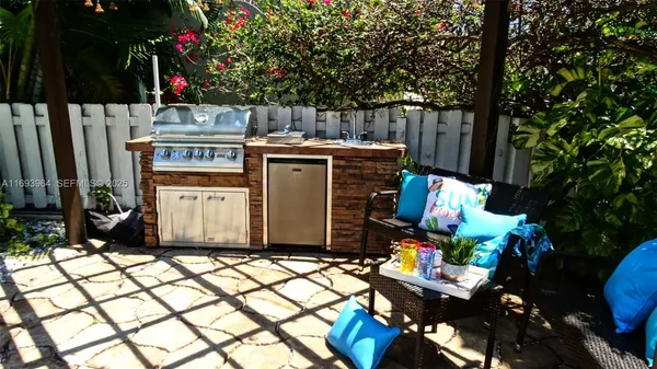 a view of a chairs and table in a backyard