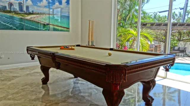 a small pool table sitting next to a window