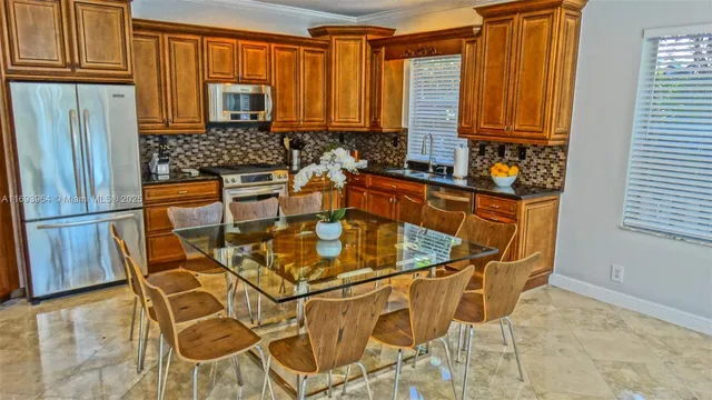 a kitchen with stainless steel appliances granite countertop a refrigerator and cabinets