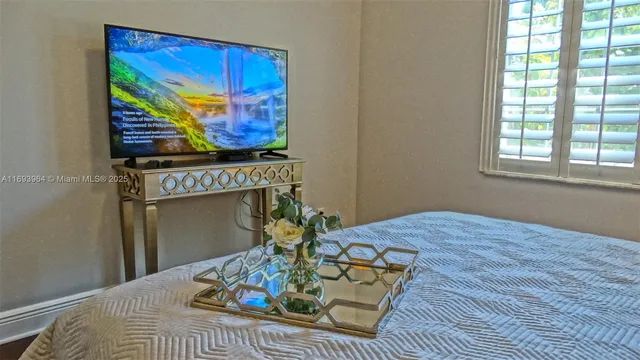 a bed sitting in a bedroom next to a window