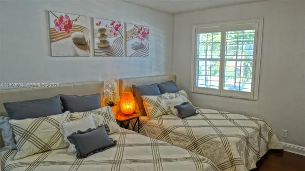 a bedroom with a bed and window