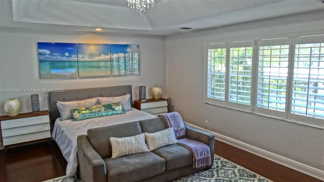 a bedroom with a bed and glass window