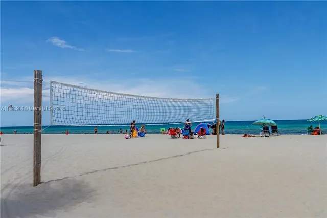 a swimming pool with a yard and palm trees