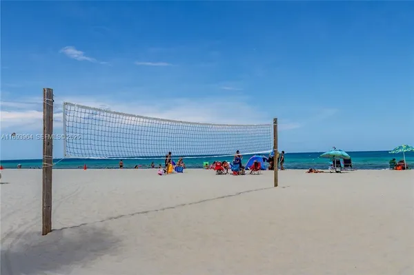 a swimming pool with a yard and palm trees