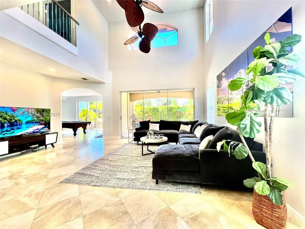 a living room with furniture and a large window