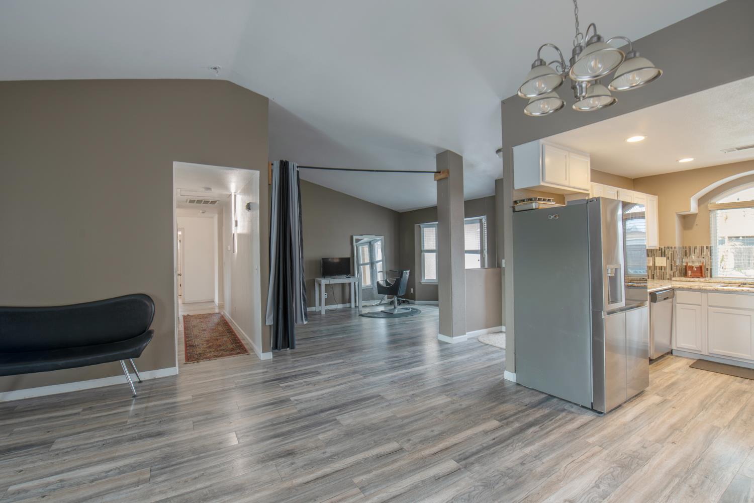 338 North Filbert Avenue Clovis, CA 93611 - Photo 12 of 33 a view of a living room and kitchen with wooden floor
