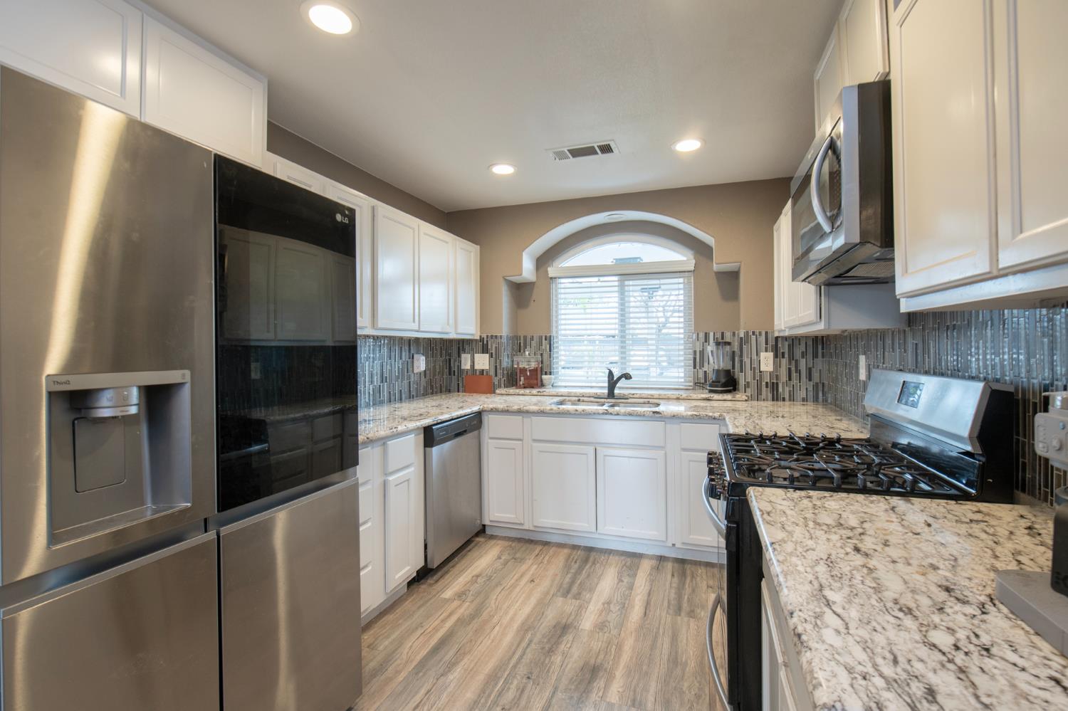 338 North Filbert Avenue Clovis, CA 93611 - Photo 13 of 33 a kitchen with a refrigerator and a sink