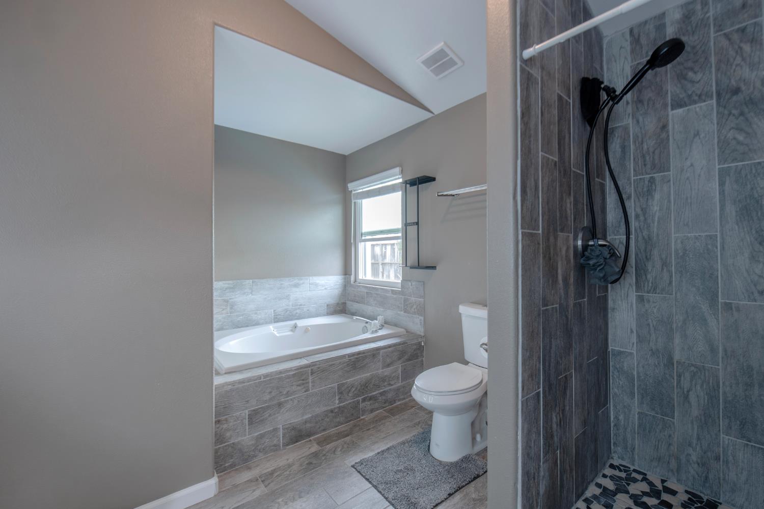 338 North Filbert Avenue Clovis, CA 93611 - Photo 19 of 33 a bathroom with a granite countertop toilet a sink and shower