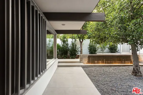 a view of balcony with floor to ceiling window and outdoor seating