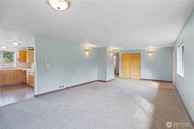 an empty room with a empty space and windows