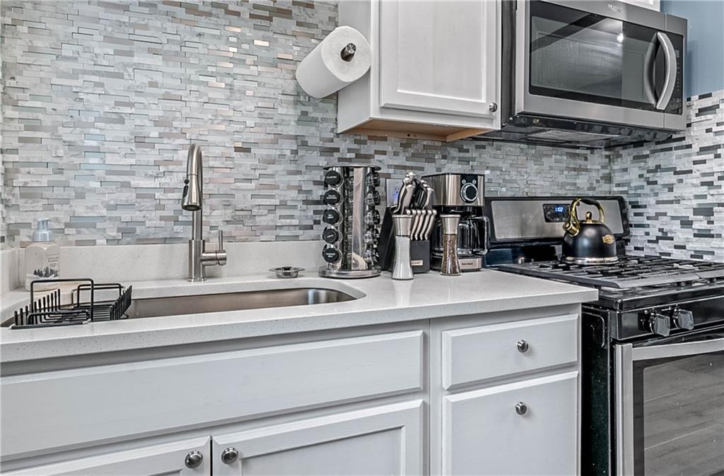 1780 John Calvin Avenue, Unit L Atlanta, GA 30337 - Photo 13 of 21 a kitchen with a stove and a microwave
