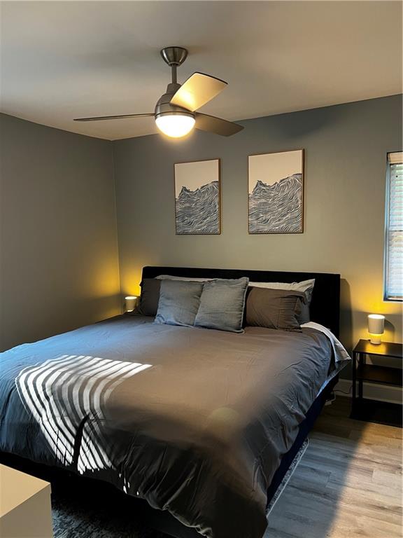 1780 John Calvin Avenue, Unit L Atlanta, GA 30337 - Photo 18 of 21 a bedroom with a bed and painting on the wall