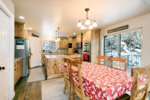 7203 East Cub River Road Preston, ID 83263 - Photo 4 of 33 Dining space with a chandelier and light wood-style flooring
