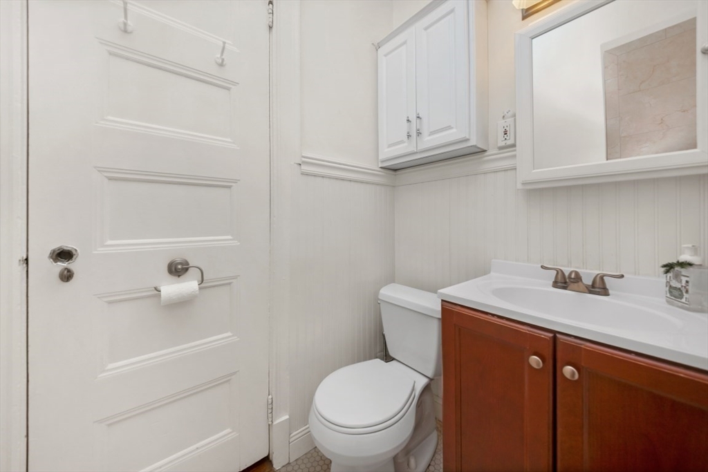 21 Beacon Street, Unit 6F Boston, MA 02108 - Photo 11 of 16 a bathroom with a sink a toilet and vanity