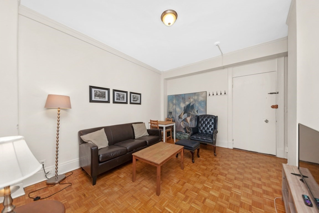 21 Beacon Street, Unit 6F Boston, MA 02108 - Photo 4 of 16 a living room with furniture and a wooden floor