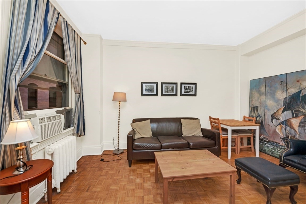 21 Beacon Street, Unit 6F Boston, MA 02108 - Photo 5 of 16 a living room with furniture and a flat screen tv