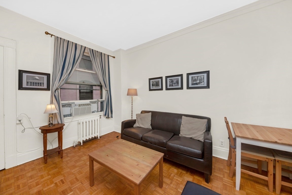 21 Beacon Street, Unit 6F Boston, MA 02108 - Photo 6 of 16 a living room with furniture and a window