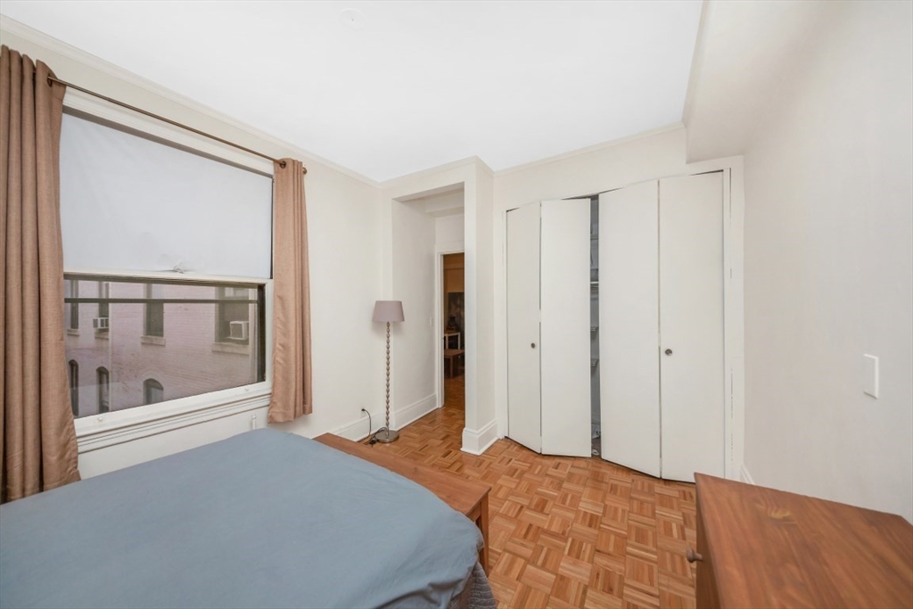 21 Beacon Street, Unit 6F Boston, MA 02108 - Photo 10 of 16 a bedroom with a bed and a large window