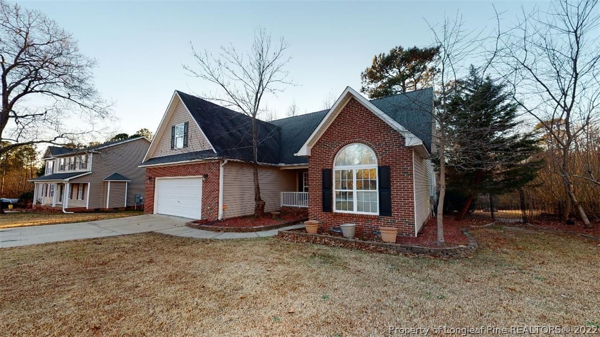 146 Pender Road Spring Lake, NC 28390 - Photo 24 of 24 a view of a house with a yard and large tree