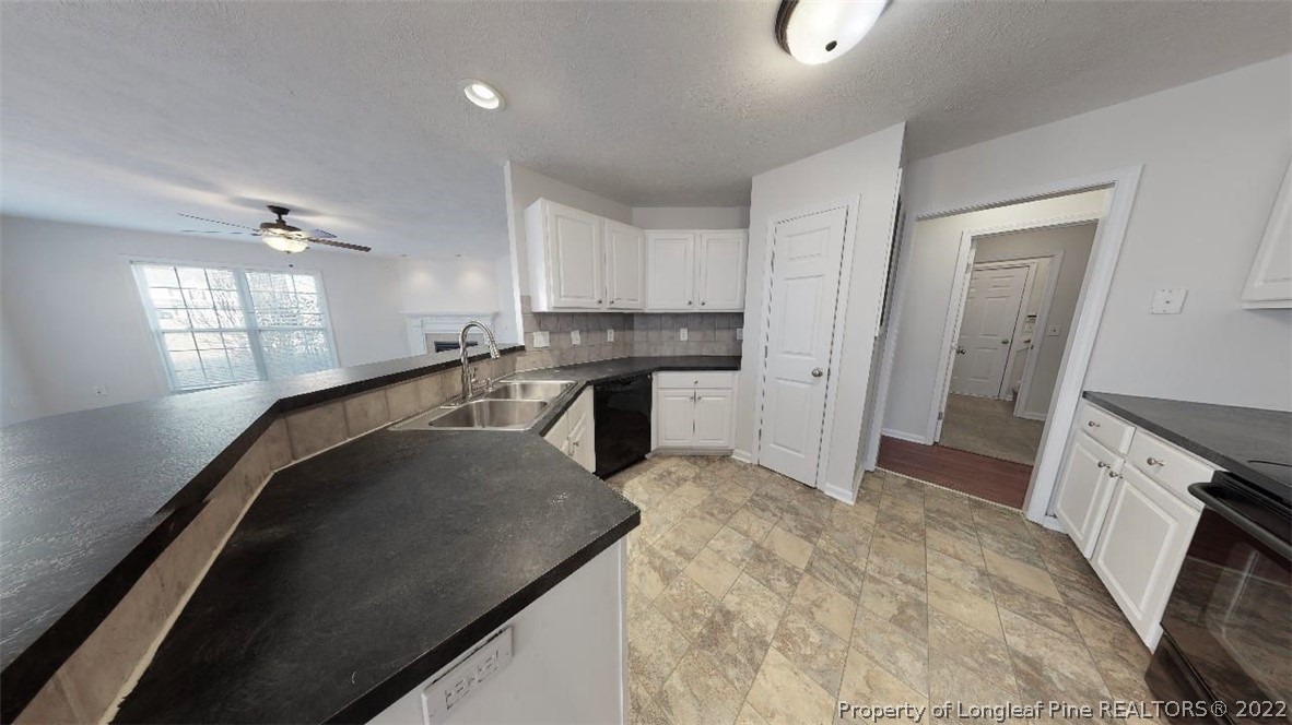 146 Pender Road Spring Lake, NC 28390 - Photo 8 of 24 a view of a kitchen with sink refrigerator and windows