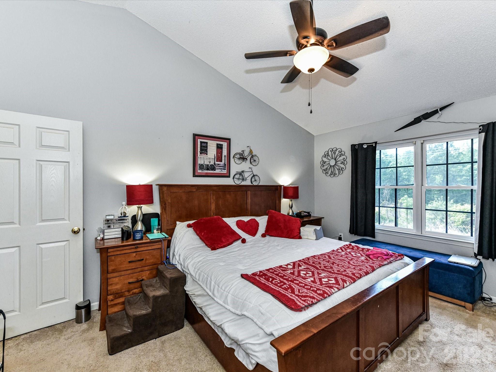 1472 Ridgewood Drive Concord, NC 28027 - Photo 15 of 30 a bedroom with a bed a dresser and a chandelier