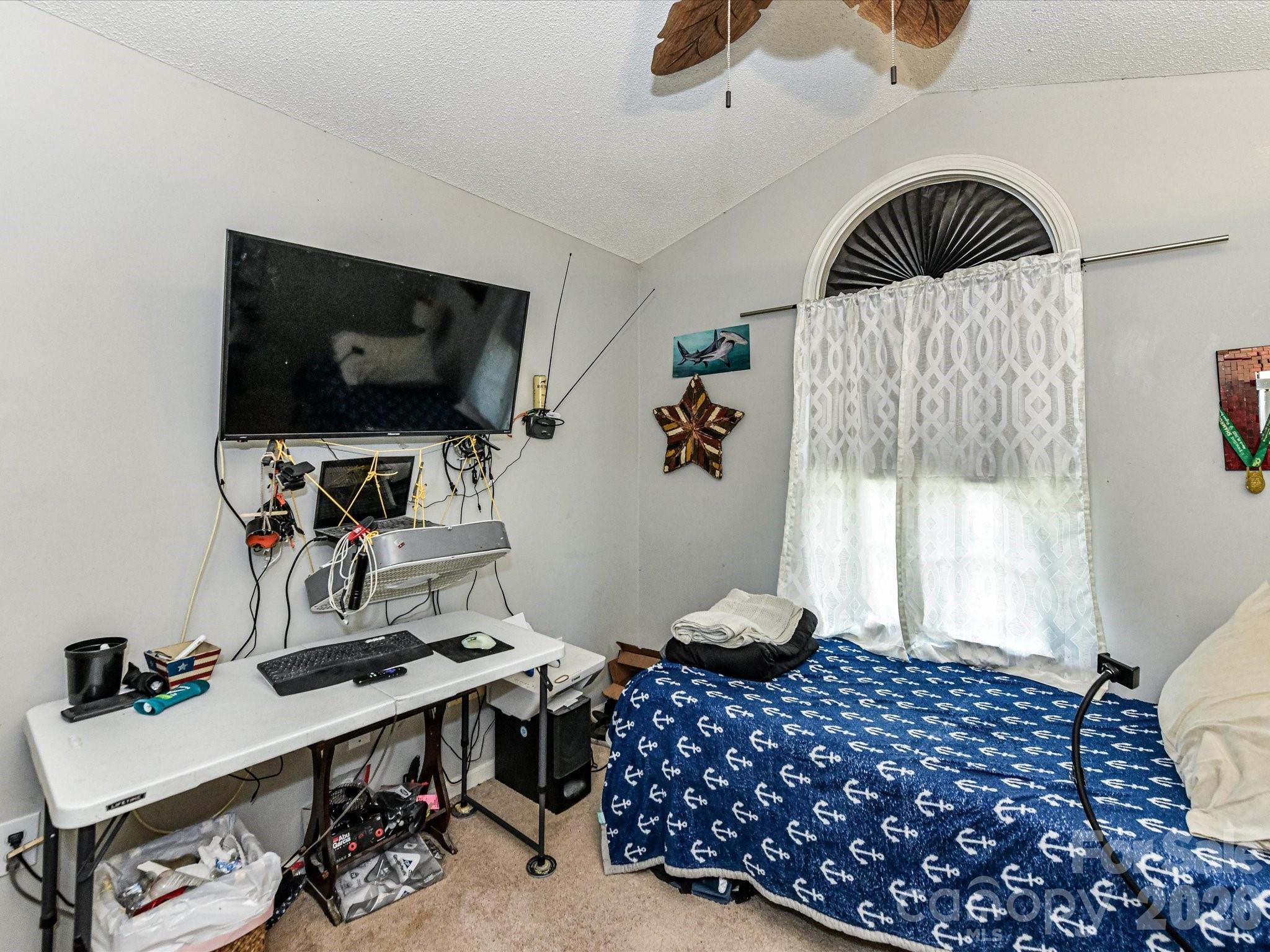 1472 Ridgewood Drive Concord, NC 28027 - Photo 21 of 30 a bedroom with a bed and a flat screen tv