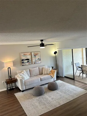 a living room with furniture and a wooden floor