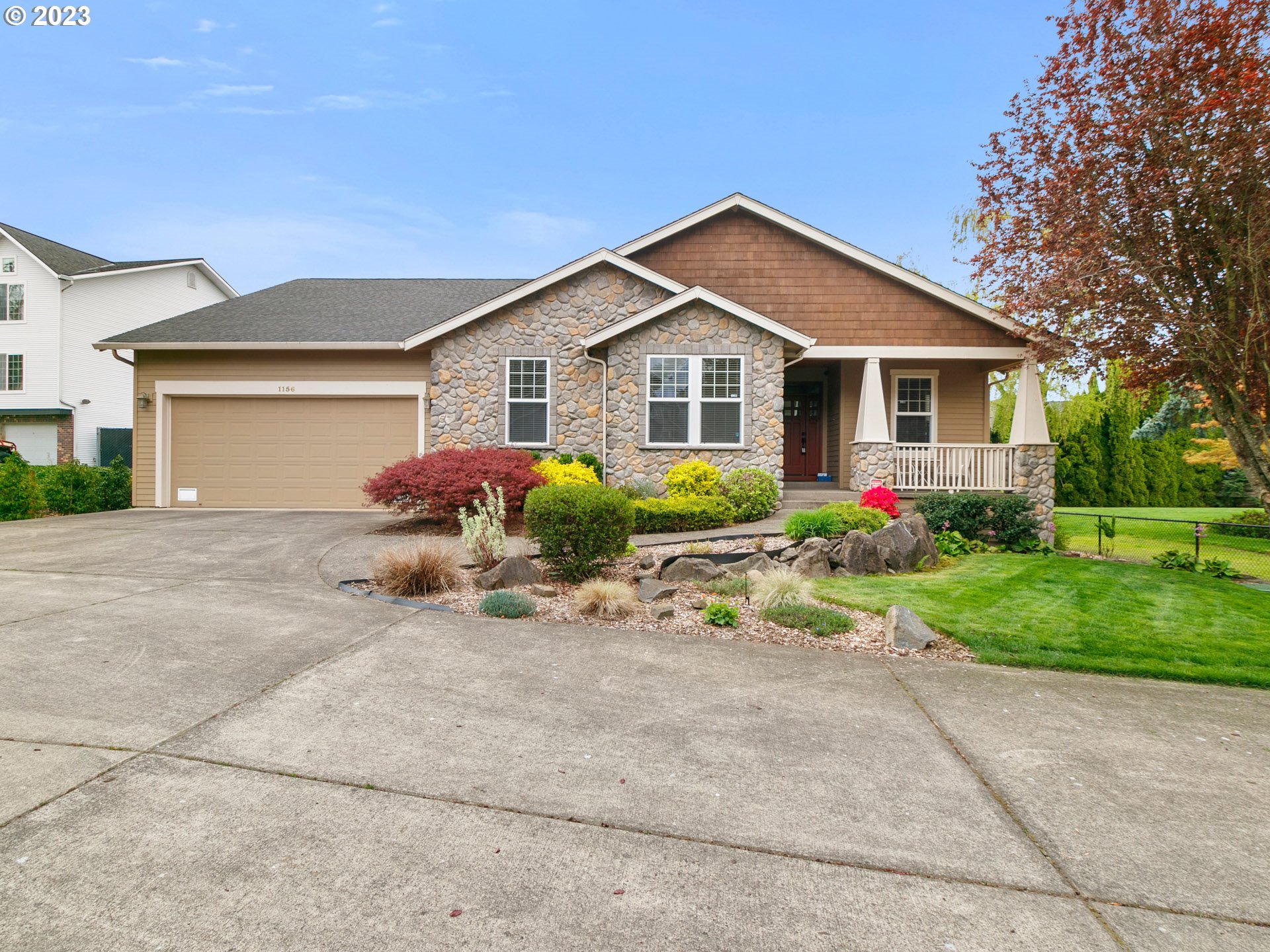 a front view of house with yard and trees around
