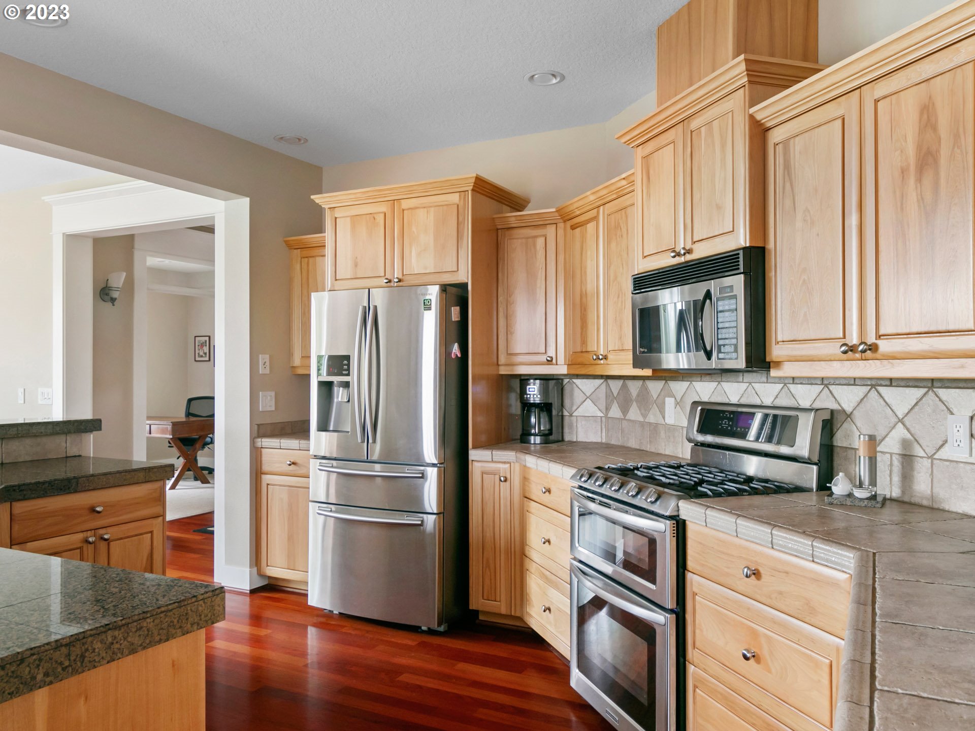 1156 Southeast Polk Street Camas, WA 98607 - Photo 12 of 34 a kitchen with stainless steel appliances granite countertop a refrigerator stove and sink