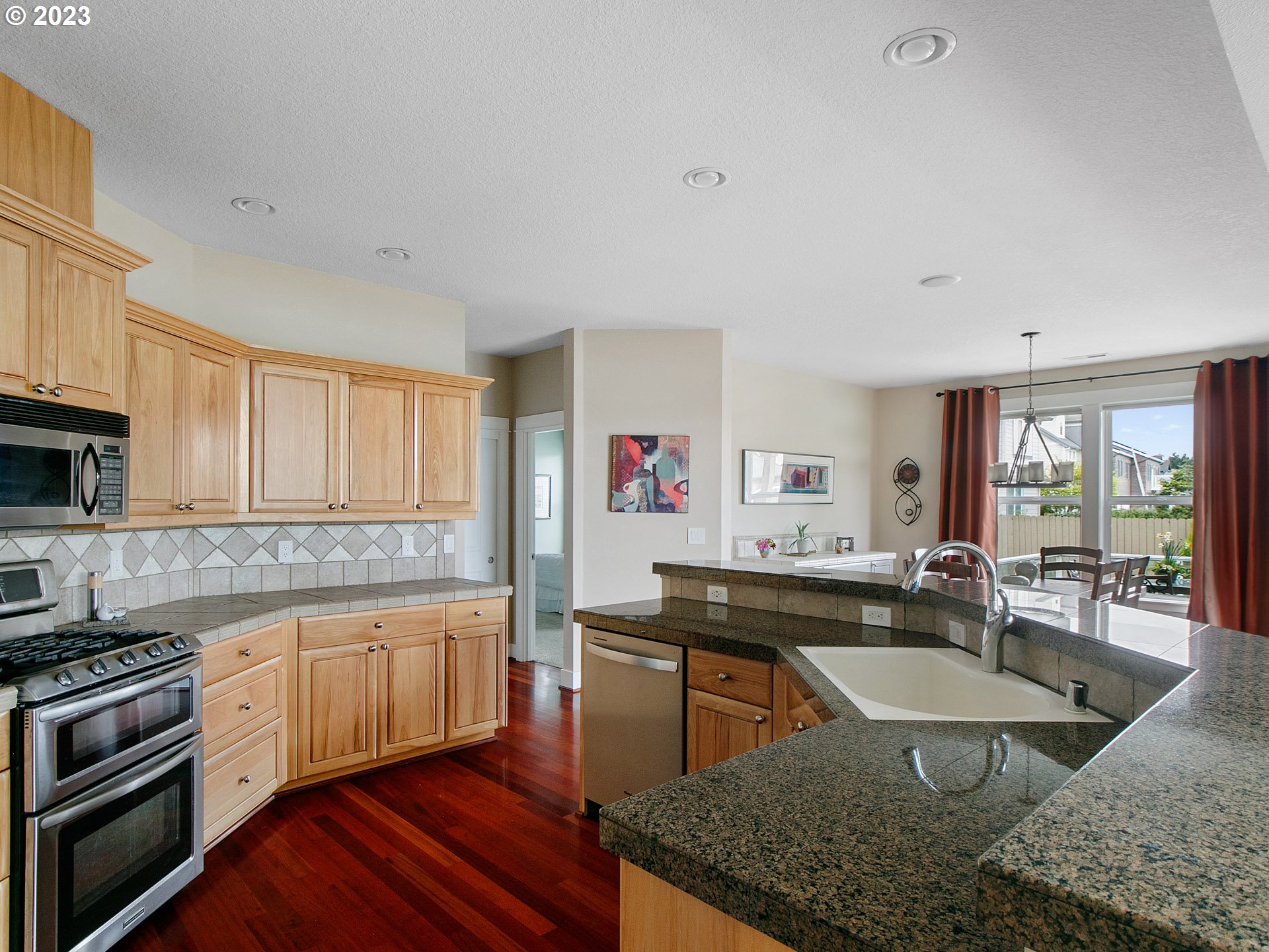 1156 Southeast Polk Street Camas, WA 98607 - Photo 13 of 34 a kitchen with stainless steel appliances granite countertop a sink a stove and a refrigerator