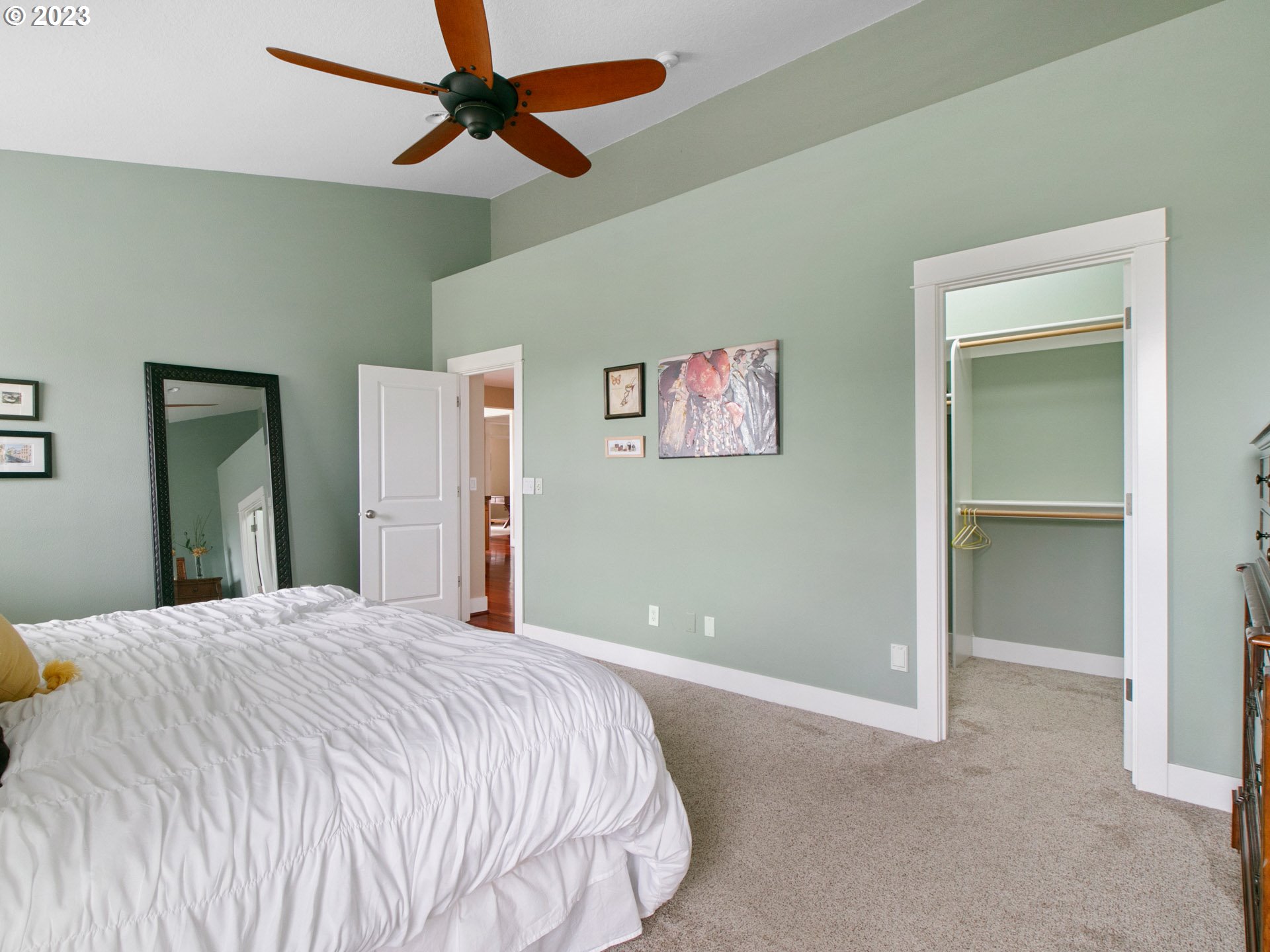 1156 Southeast Polk Street Camas, WA 98607 - Photo 18 of 34 a bedroom with a large bed and a chandelier
