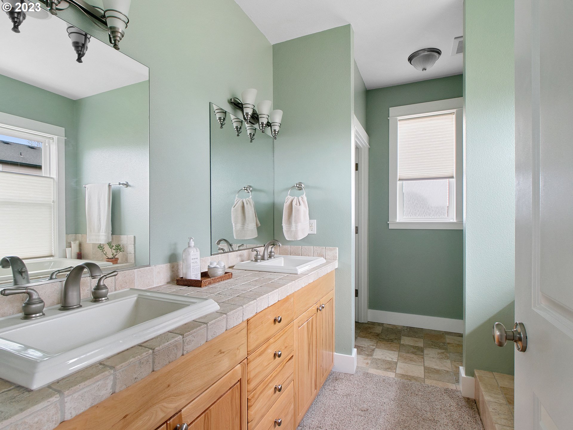 1156 Southeast Polk Street Camas, WA 98607 - Photo 19 of 34 a bathroom with a double vanity sink and a mirror
