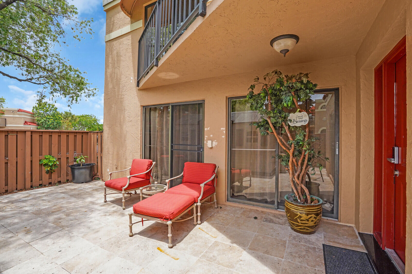 8291 Thames Boulevard, Unit C Boca Raton, FL 33433 - Photo 11 of 20 a outdoor space with chairs and a potted plant