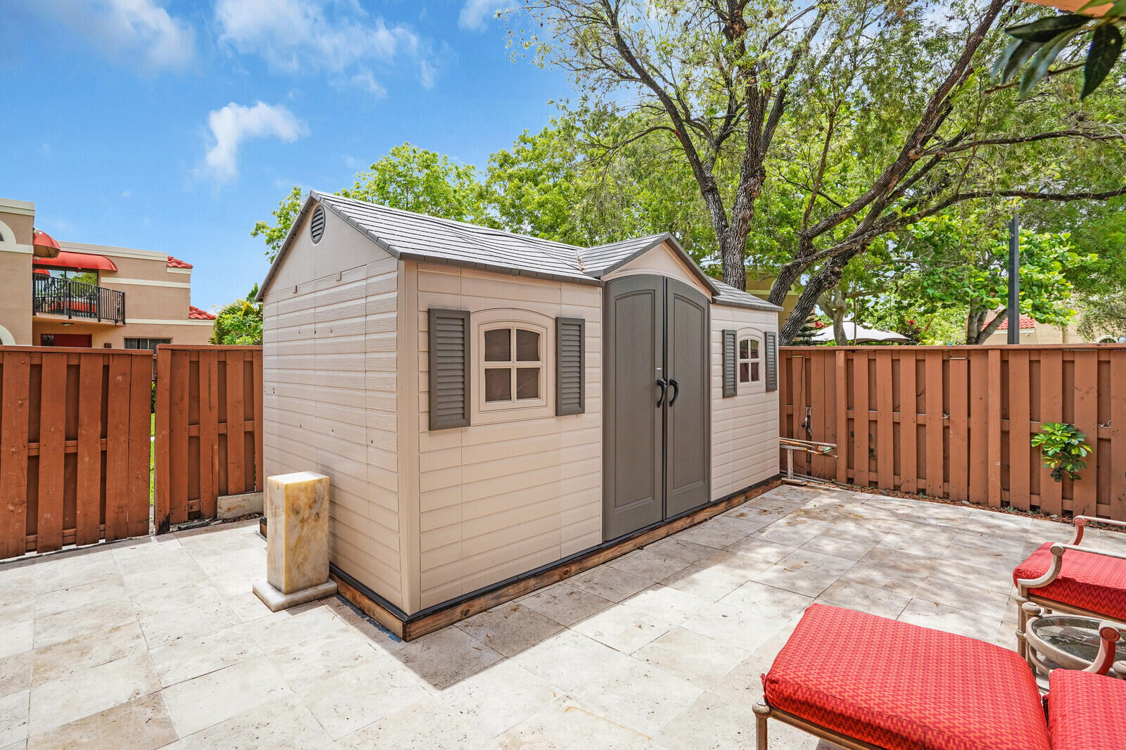 8291 Thames Boulevard, Unit C Boca Raton, FL 33433 - Photo 12 of 20 a view of backyard with small cabin and wooden fence