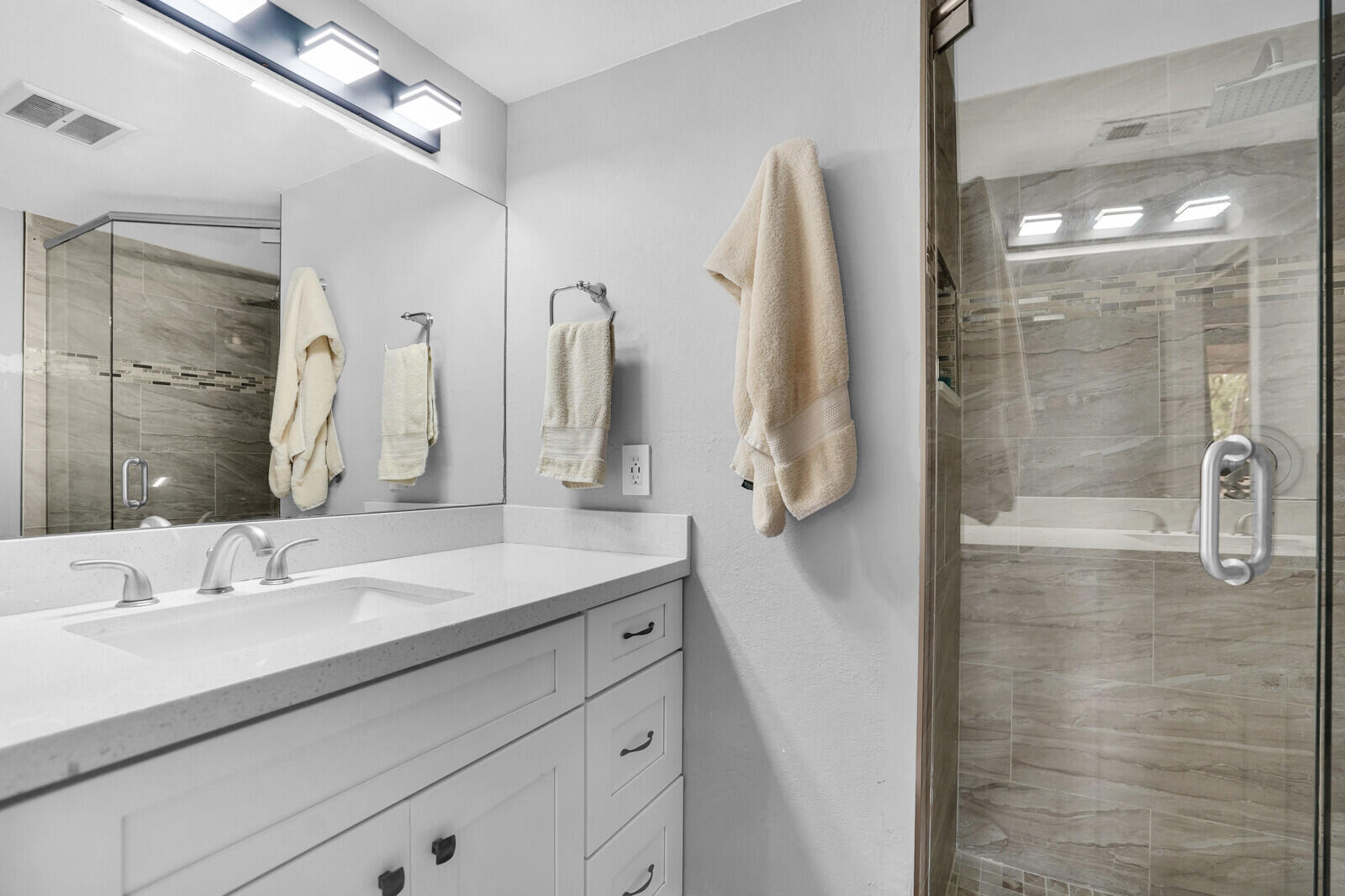 8291 Thames Boulevard, Unit C Boca Raton, FL 33433 - Photo 16 of 20 a bathroom with a double vanity sink mirror and shower