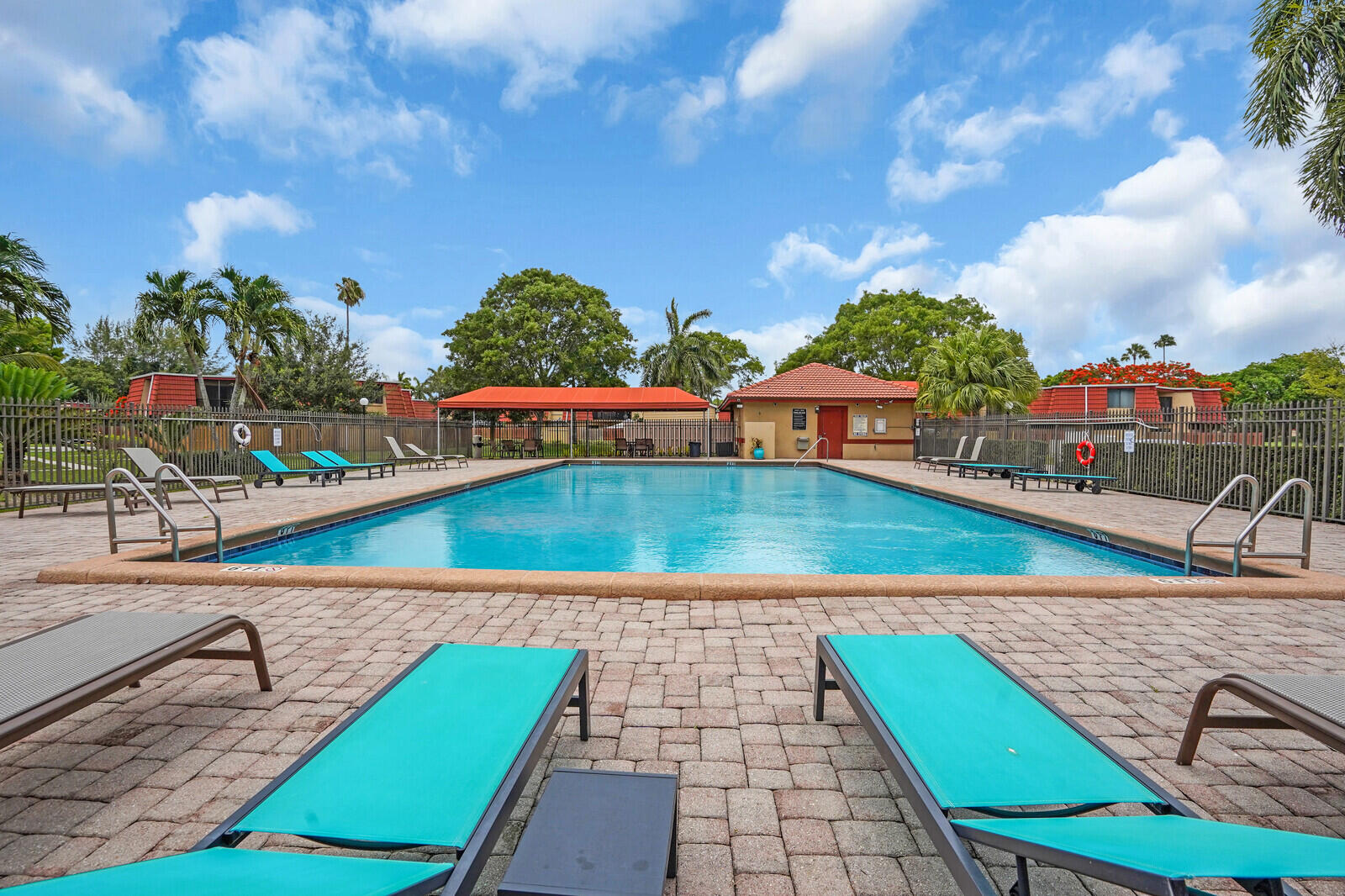 8291 Thames Boulevard, Unit C Boca Raton, FL 33433 - Photo 20 of 20 a view of a swimming pool with a lounge chairs