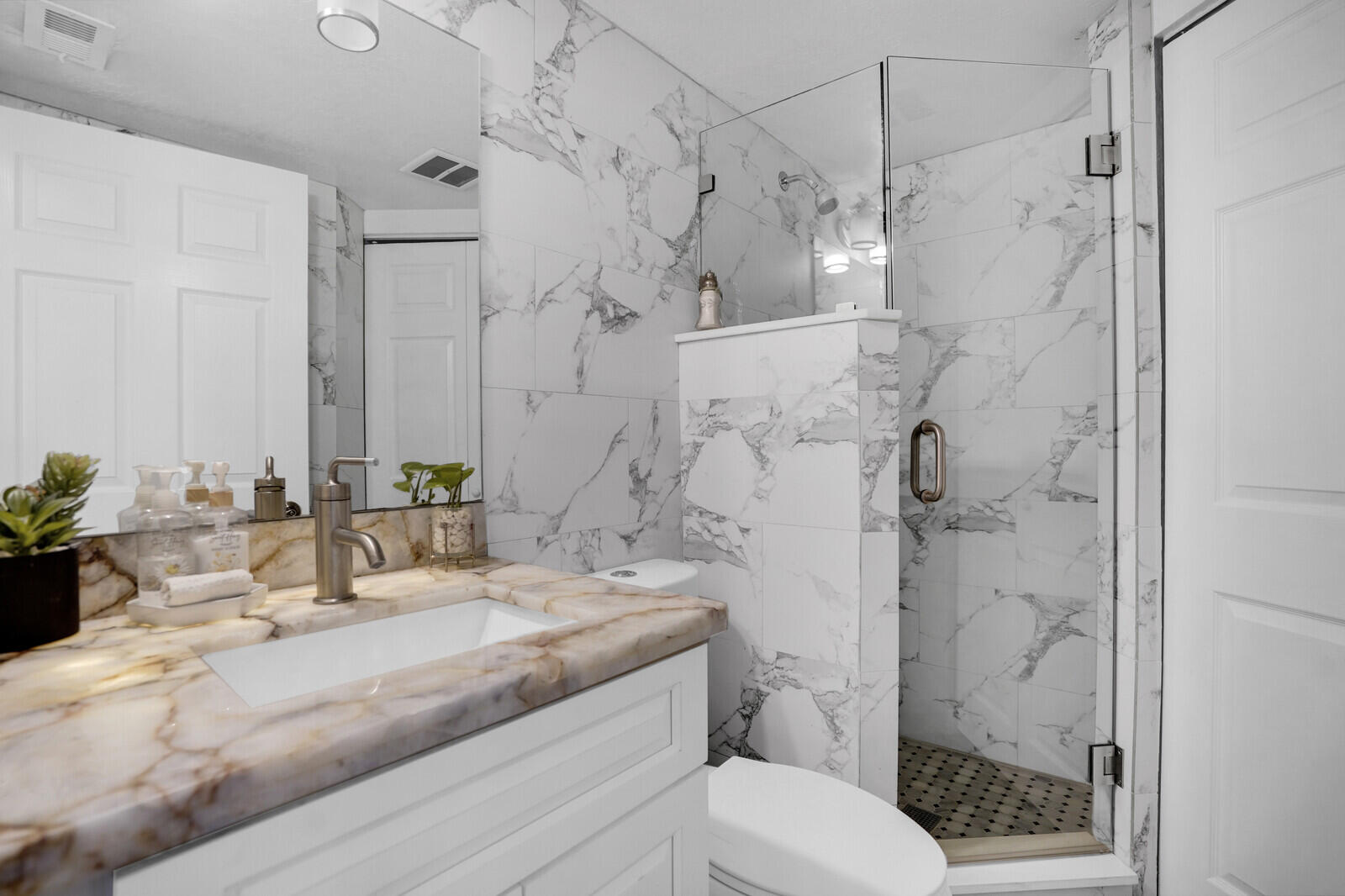 8291 Thames Boulevard, Unit C Boca Raton, FL 33433 - Photo 8 of 20 a bathroom with a granite countertop sink a toilet and shower