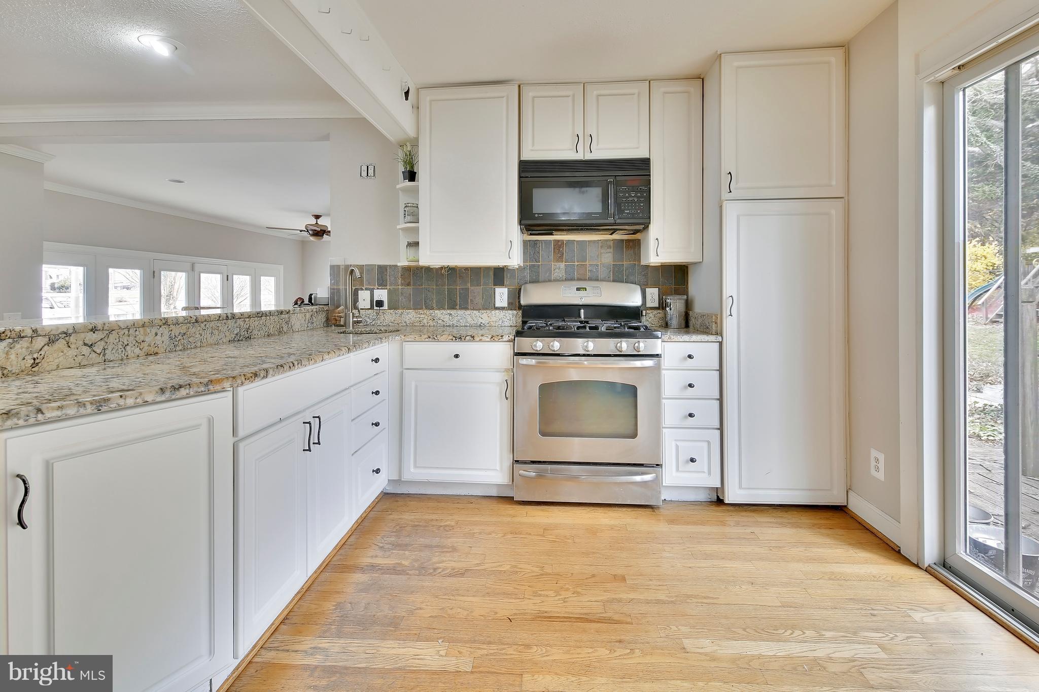 956 Shore Acres Road Arnold, MD 21012 - Photo 4 of 30 Kitchen w/ granite counters and sliders to Deck