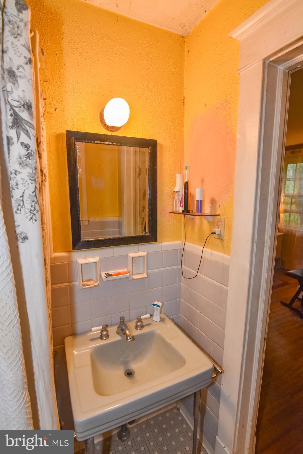 24 Merrymount Road Baltimore, MD 21210 - Photo 30 of 48 a bathroom with a sink and a mirror