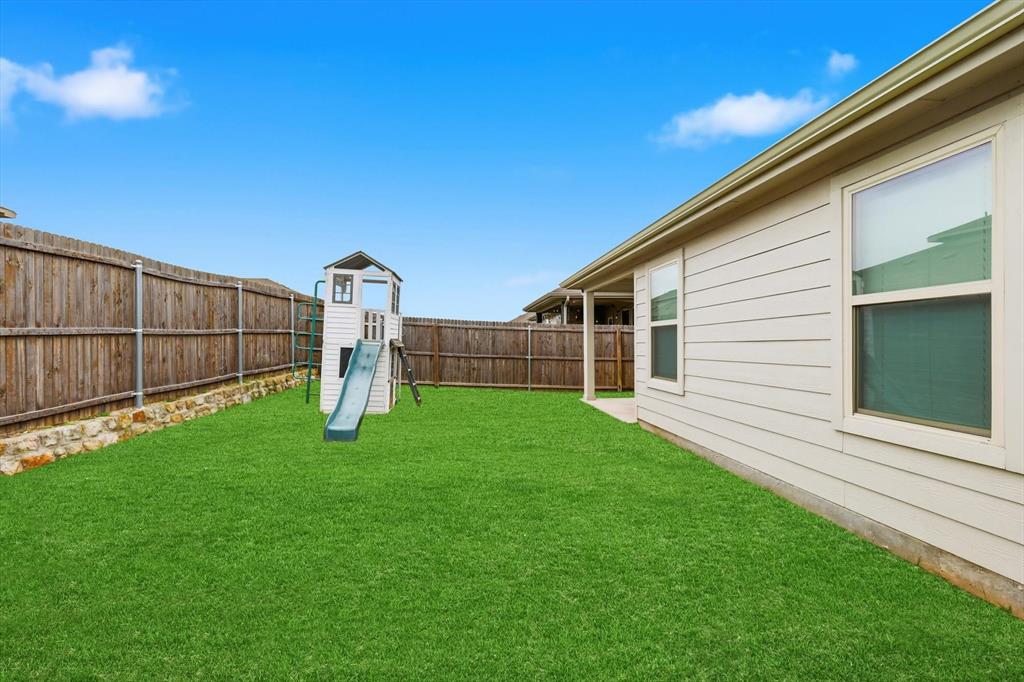 2416 Wildhaven Road Crandall, TX 75114 - Photo 28 of 35 a view of a backyard with a garden